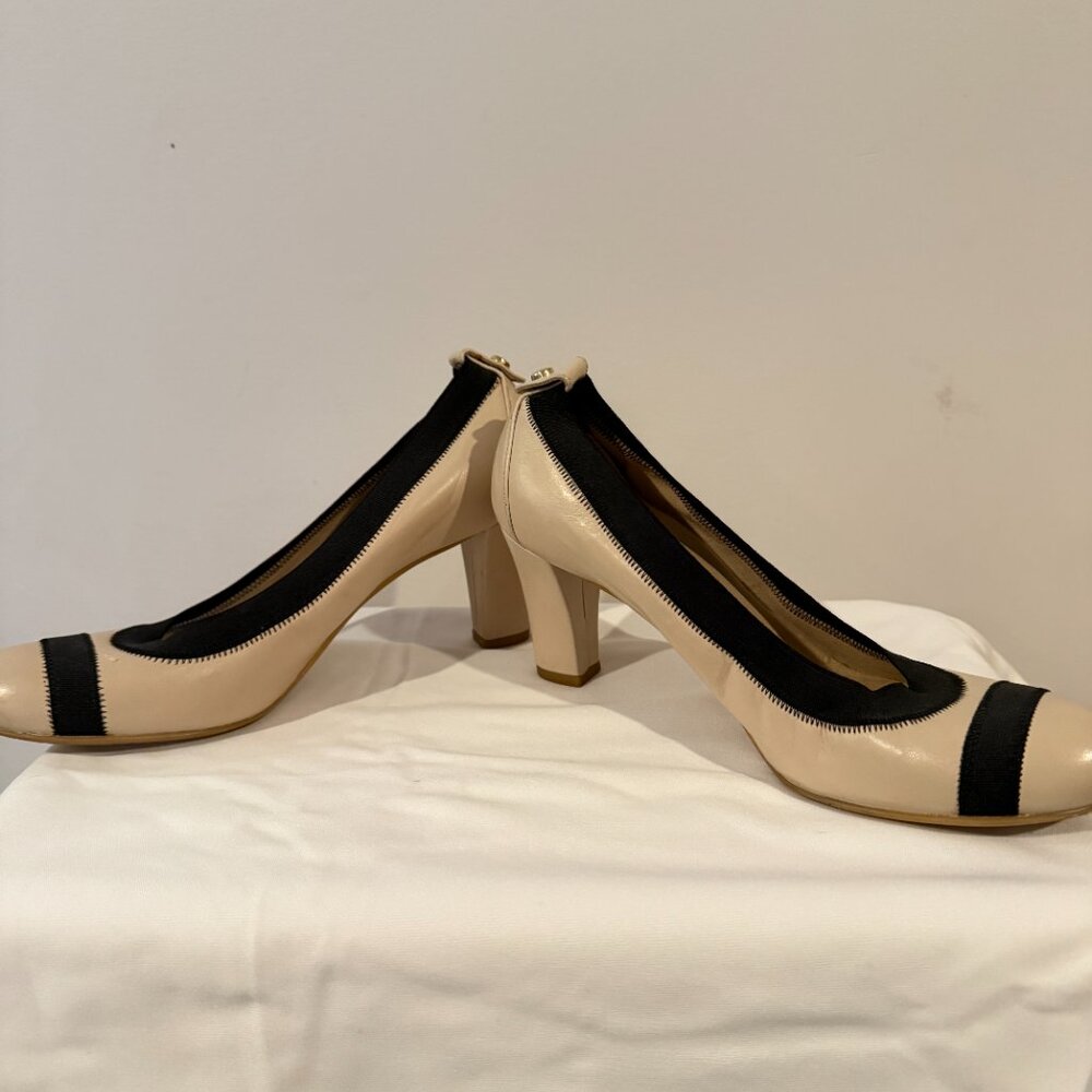 Stuart Weitzman, size 6.  Bone patent leather in color with black accents.